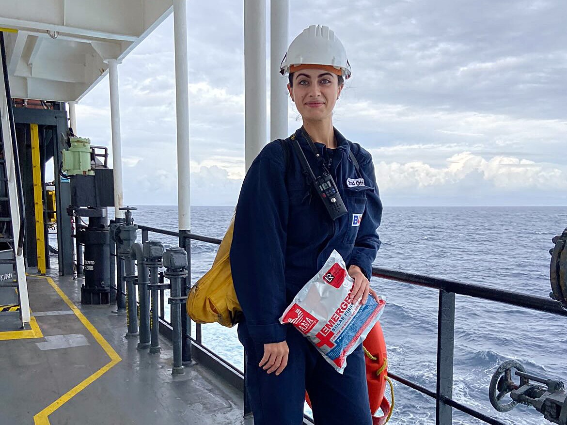 Trabajadora de pie en la cubierta de un barco